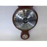 A 20th Century Aneroid Wheel Barometer with break-arch pediment and Brass finial to a moulded neck