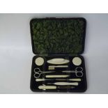 An early 20th Century cased Manicure Set to include scissors, buffers, files etc