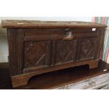 An 18th Century and later carved Oak Coffer, the lifting lid carved in the centre with head of a man