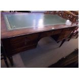 A Mahogany Large Desk with a gilt tooled green leather inset and with moulded sides and front,