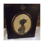 19th Century silhouette picture of a young Lady in ebonised frame, with loop hanger with acorn