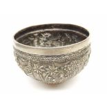 An early 20th Century Indian white metal Bowl, embossed with a continuous village scene, the plain