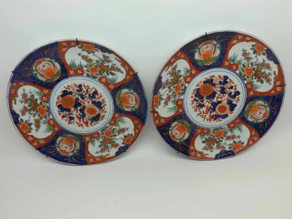 A pair of Japanese Imari Wall Plates of circular form, typically decorated in traditional colours