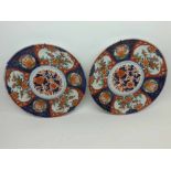 A pair of Japanese Imari Wall Plates of circular form, typically decorated in traditional colours