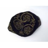 An early 20th Century Gentleman's Velvet Smoking Cap decorated throughout with gilt braiding