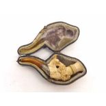 A cased Meerschaum Pipe, the bowl carved with deer's head (lacking antlers), white metal collar,