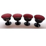A set of four 19th Century Purple Glass Pedestal Fruit Bowls, raised on knopped stems and