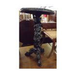 An unusual Oriental Ebony or Hardwood Pedestal Table, the top with a veined marble inset, (cracked),