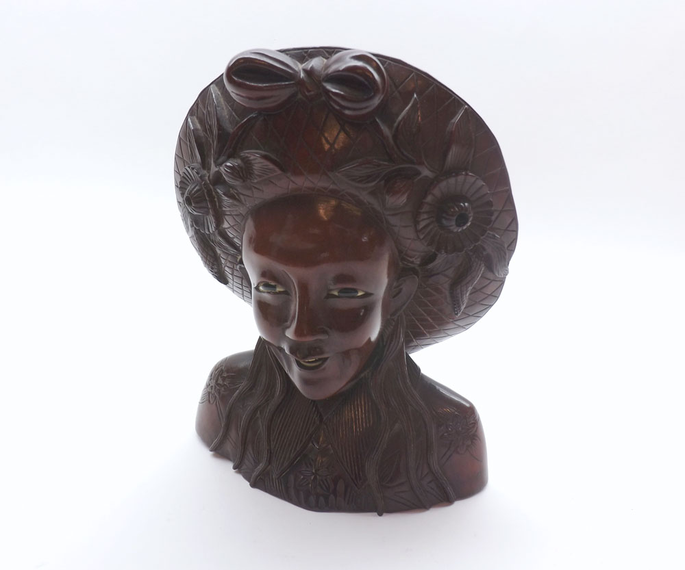 20th Century Oriental carved bust of a female figure in broad floral decorated hat, 8" high