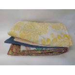 Four vintage cotton bed covers of various colours and designs together with a cotton Paisley