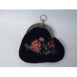 A late 19th Century Gros Point needle tapestry evening purse with decorative Continental Silver