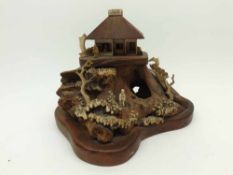 An unusual Chinese Bone/Ivory and Hardwood Model of a pagoda atop a rocky incline and also applied