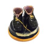 A Majolica Match Case modelled as two boots, raised on a circular base, the base impressed "