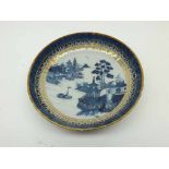 A Chinese Bowl, the centre painted in underglaze blue with a Chinese river scene within a gilded