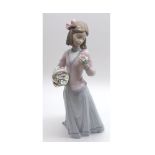 A Lladro (Collectors Society) Figure, young girl with a basket of flowers under her right arm, and a