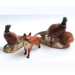 Three Beswick Models: pair of Pheasants, 2078; Pheasant, 1226; Fox (standing), 1016A gloss finish;