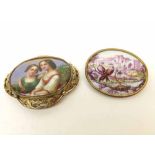 A large Victorian Pinchbeck framed Brooch featuring a centre hand painted ceramic panel of two