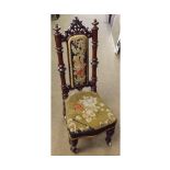 A Victorian Nursing Chair, the turned mahogany frame with tapestry inset back and seat, raised on