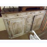 An Oak Dresser Base, dark oak top over a limed oak base with three frieze drawers over four