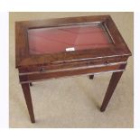 Early 20th Century Mahogany Bijouterie Table, glazed top over a plush lined drawer, raised on