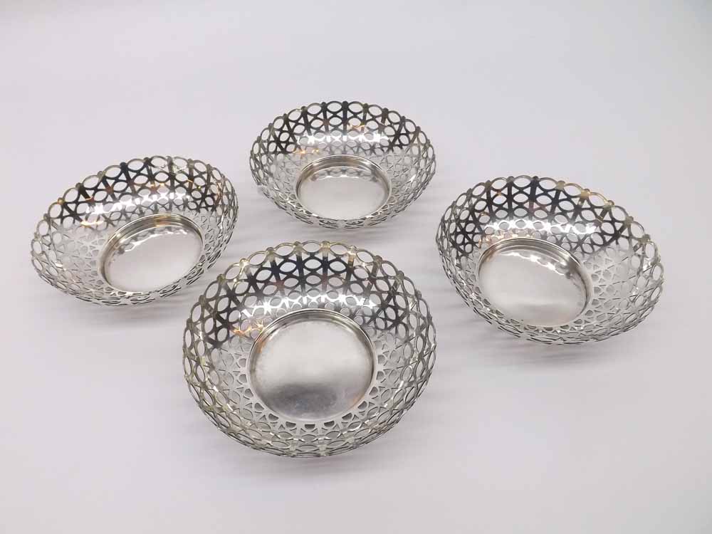 A set of four Edwardian Circular Bon-Bon Dishes, pierced with bands of oval designs, wavy rims, 9