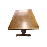 A 20th Century Rectangular Oak Draw Leaf Dining Table, raised on heavy carved bulbous legs and a