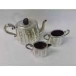 A late Victorian Electroplated Three Piece Tea Set of tapering oval form, foliate and medallion