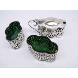 An attractive Edwardian Three Piece Condiment Set of lobed oval form, foliate pierced sides,