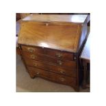 An early 19th Century Mahogany Bureau of typical form, the fall front opening to an interior of