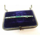 An early 20th Century mid-grade yellow metal curbed bar Brooch, pave set with rectangular cut