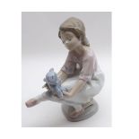 A Lladro (Collectors Society Edition) Figure of a young girl seated on a pouffe with teddy bear on