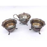 A Three Piece Condiment Set in Edwardian style, circular shaped with wavy rim, each item supported