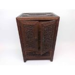 A Chinese Hardwood Carved Table Top Cabinet, applied on either side with ring handles and with two
