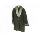 A Ladies green boiled wool three-quarter length coat with faux fur collar and cuff detail