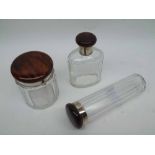 A set of three George V facetted Cut Glass Toiletry Bottles with simulated tortoiseshell lids, 7 1/2