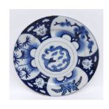 An Oriental Circular Plate, painted in underglaze blue with compartmentalised design of grotesque