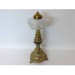 A decorative Brass Based Oil Lamp with clear glass facetted font, 20” high