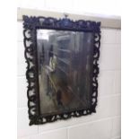 A 19th Century Oak Rectangular Wall Mirror with a scroll and foliate carved pierced border, glass