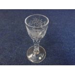 An 18th Century style Wine Glass with floral sprig and bird engraved bowl, raised on a facetted stem