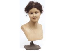 Antique shop display head and shoulders mannequin of female figure raised on a cast metal base,