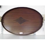 An Edwardian Mahogany Oval Tray, applied at either end with brass handles and central inlaid panel