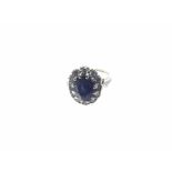 A mid-20th Century hallmarked 18ct White Gold Cluster Ring, featuring a centre oval sapphire