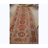 A large Kilim Runner, central panel of interlinked lozenges mainly khaki, beige and brown field,