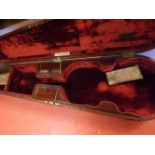 A late 19th Century Mahogany coffin shaped violin case with red velvet lined interior together