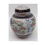 An Oriental Covered Ginger Jar of baluster form, the body and lid painted in colours with stylised