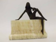 Art Deco style Bronze model of a seated young lady raised on a polished marble plinth base of