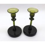 Pair of green glass Candlesticks of circular form, the bases with ground pontil marks, no makers