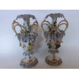A pair of decorative European two-handled urn-shaped Vases, encrusted throughout with flowers and