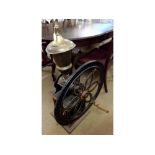 A Vintage Large Coffee Grinder with brass container over cast metal large wheel, with container