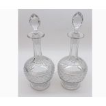 Pair of early 20th Century clear cut glass Decanters of onion form decorated with star cut bases, 12